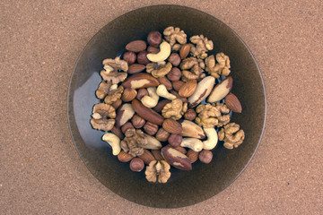 Different kinds of nuts on a plate. Healthy and protein food.