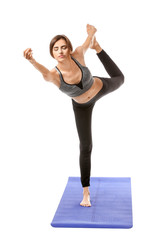 Beautiful young woman practicing yoga on white background