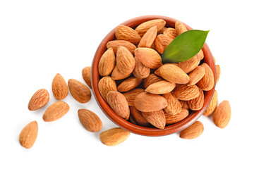 Bowl with tasty almonds on white background