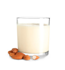 Glass of fresh almond milk on white background