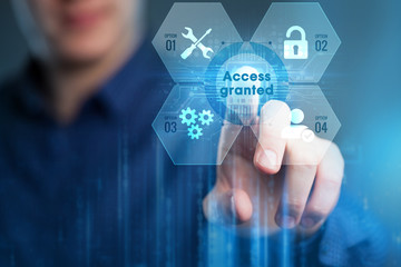 Business, Technology, Internet and network concept. Young businessman working on a virtual screen of the future and sees the inscription:Access granted.