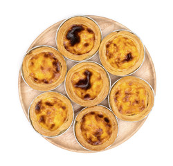 egg tart in aluminum foil cup isolated on white background,top view