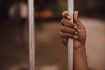 Hands of women desperate to catch the iron prison,prisoner concept,Hope to be free.