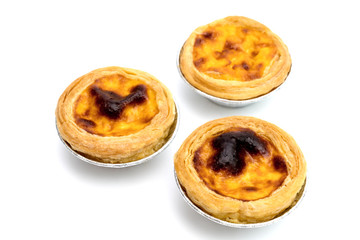 egg tart in aluminum foil cup isolated on white background