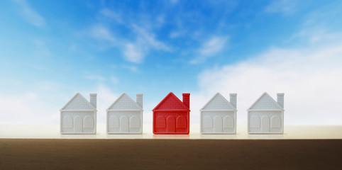 Red house among white houses, search concept