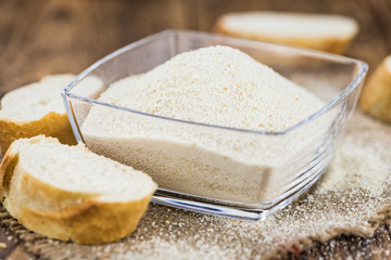 Vintage wooden table with Bread Crumbs (selective focus; close-up shot)
