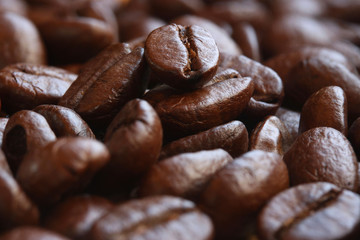 Closed up pile of roasted coffee beans. Selective focus..