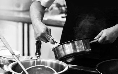 chef cooking in a kitchen, chef at work, Black & White background