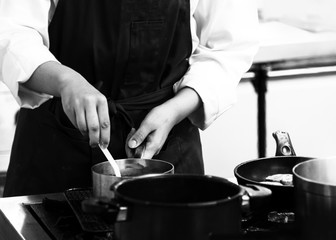 chef cooking in a kitchen, chef at work, Black & White background