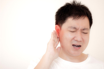 Men suffering from severe ear pain are caused by an infection causing red ear inflammation,Concept healthcare and medical.