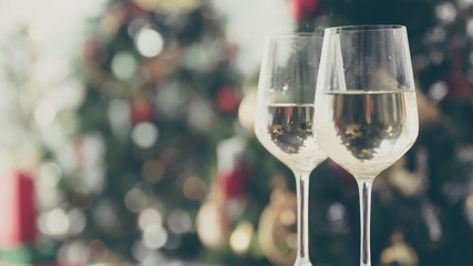 Christmas and new year eve party with champagne and blurred background ornament decorated tree