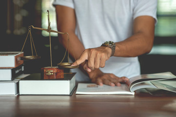 Legal concept of law Lawyers read legal documents and agreements on office desks.