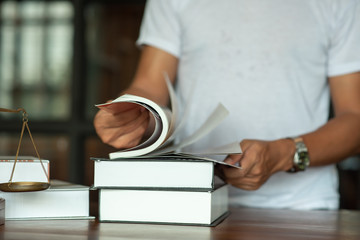 Legal concept of law Lawyers read legal documents and agreements on office desks.