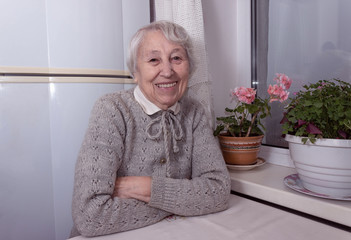 Portrait of smiling senior woman, looking at camera.