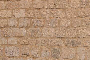 Background texture of the old fortress stone wall. Conceptual background for designers. Selective focus.