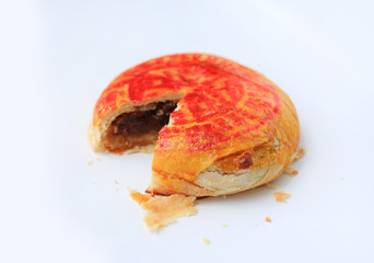 Traditional Chinese pastry or moon cake with lucky word printed on top isolated on white background.