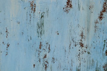 The metal surface is carelessly painted in blue, traces of rust.