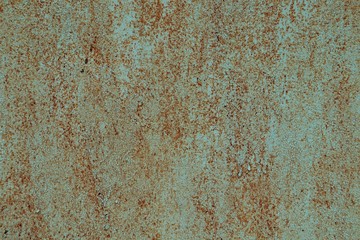 The metal surface is painted green, a lot of rust.