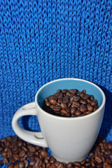coffee beans in the white cup on the blue background