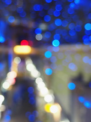 Christmas theme with blue garland. Blurred image of lightst in the dark. Bokeh of streetlights. Abstract background. Soft focus.