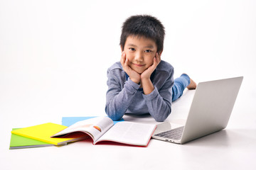 Asian Little kid with pile of books and laptop lying on white background, Education Learning School Concept