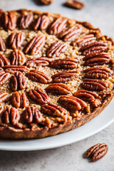Pecan Pie on gray-brown background. Vegan dessert concept.
