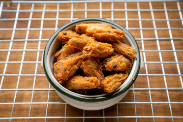 Deep-fried prawns and small crabs fried on a wooden table, Crispy fried shrimp placed on a wooden table , assortment of fried seafood on the table,Fried crab