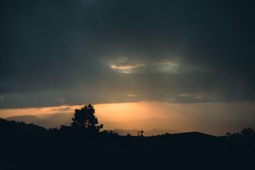 sunset in the mountains orange overcast foggy misty sky