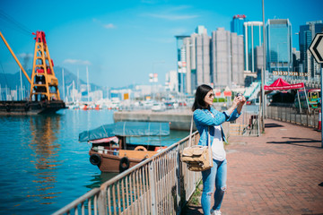 Girl traveling in Hong Kong Causeway Bay waterfront.