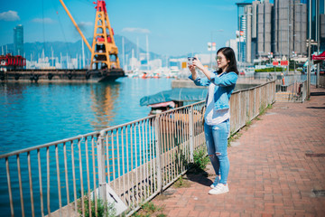 Fototapeta na wymiar Girl traveling in Hong Kong Causeway Bay waterfront.