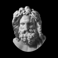 Gypsum copy of antique statue Zeus head isolated on black background. Plaster sculpture man face with beard.