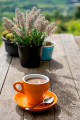 Hot coffee placed on the table in the morning with mountain views