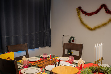 Empty dining room is decorated with Christmas tree and gift presents for Christmas Day at night festival coming soon as background