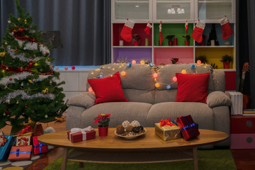 Empty living room is decorated with Christmas tree and gift presents for Christmas Day at night festival coming soon as background