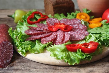 Salami slices on the salad leaves