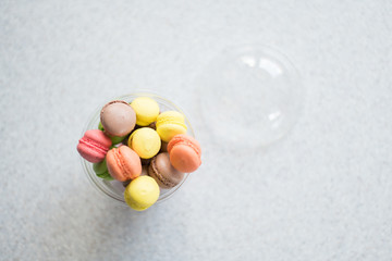 Mini macarons cakes in a package slide on a gray background