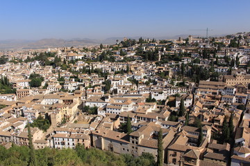 Fototapeta na wymiar Aerial view of the Albaicin city taken from Tower of the Cubo (Cube Tower) of the historical Alhambra Palace complex in Granada, Andalusia, Spain.