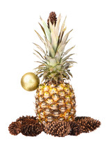 Pineapple is decorated with a Christmas tree toy and Christmas tree cones.