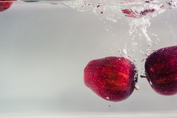 Red apples that are released into the water
