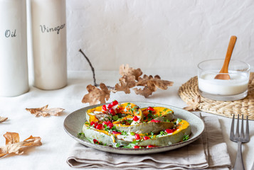 Grilled pumpkin with pomegranate and white sauce. Healthy eating.