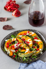 Grilled pumpkin with pomegranate and white sauce. Healthy eating.
