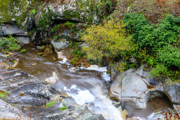 Eresma river as it passes through Boca del Asno among the granite rocks in Valsain, Segovia, Spain