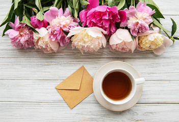 Cup of tea and pink peonies