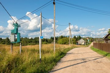 Electricity transformer substation mounted on the side of a country road in the village