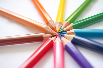 Fototapeta premium Colorful colored pencils close up, art supplies for painting education in classroom, kids stationary in school on white background, rainbow unicorn color, diversity,happy life, gay pride, lgbt concept