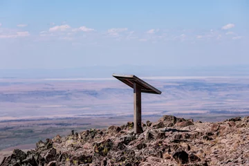 Foto op Canvas Isolated metal information stand on a top of a Steens mountain summit. © Dmitry