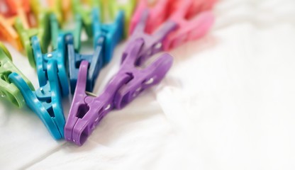 Plastic clothespins on white background, colorful rainbow unicorn color, vibrant object group, laundry, housewife, lgbt flag, freedom, creativity, teamwork, movement or diversity concept