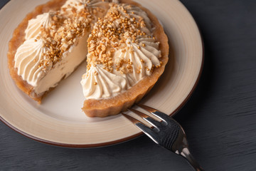 Dessert basket with caramel cut and lies on a plate next to a fork for dessert.