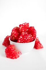 Pomegranate seeds pattern pink color fruit, juicy healthy fruit seed on white background, copy space