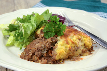 shepherd's pie with salad on a plate